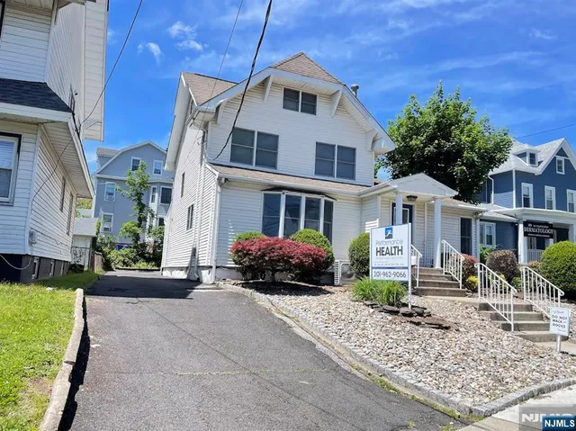 a front view of a residential houses with yard
