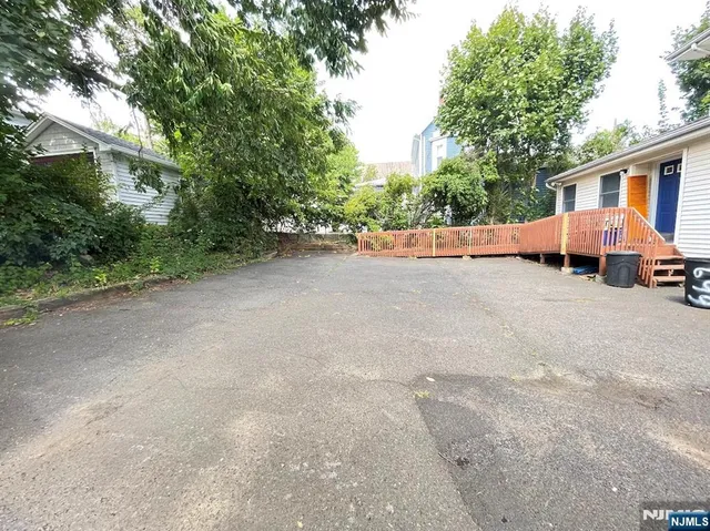 a view of house with outdoor space and trees around