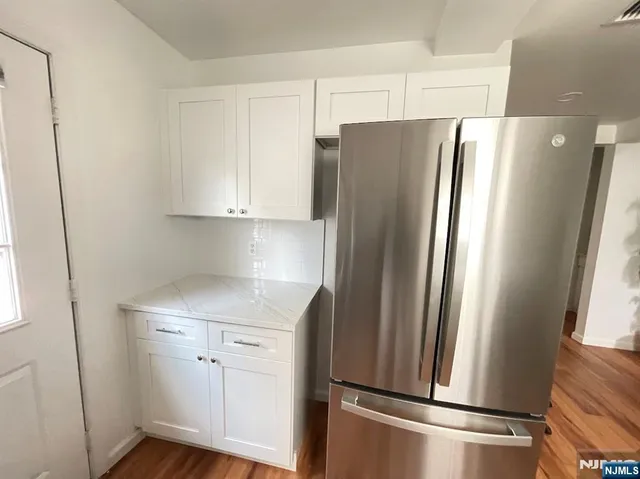 a kitchen with stainless steel appliances a refrigerator and a sink