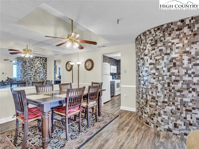 a view of a dining room with furniture and chandelier