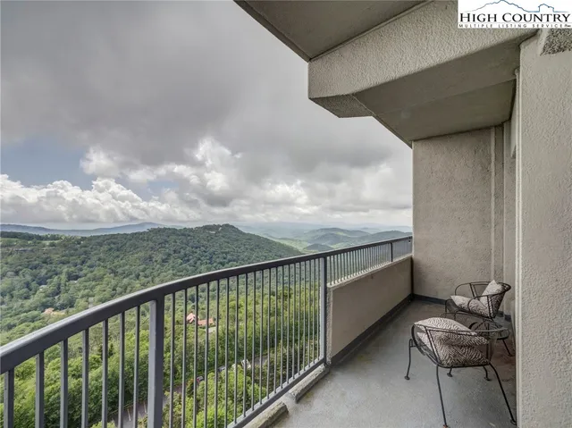 a balcony with an outdoor seating