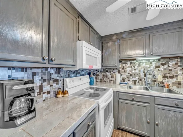 a kitchen with sink and cabinets