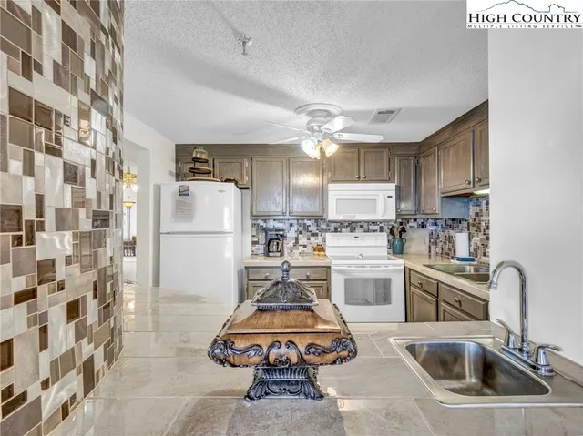 a kitchen with refrigerator a sink and cabinets