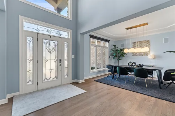a kitchen with white cabinets and refrigerator