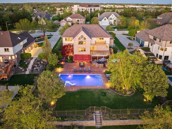 an aerial view of residential houses with outdoor space and street view