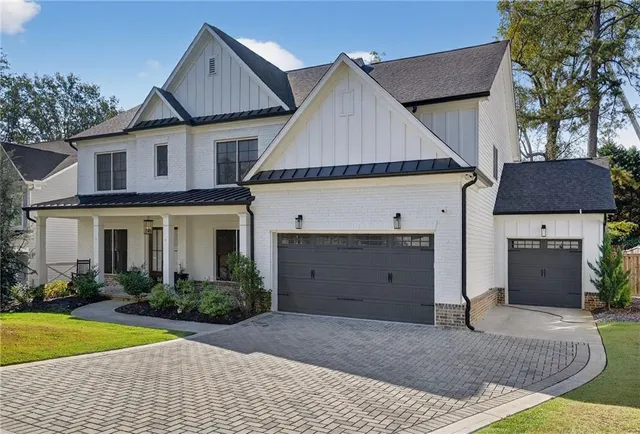 a view of a house with a yard and a garage