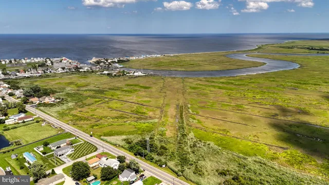 a view of a lake with lawn chairs