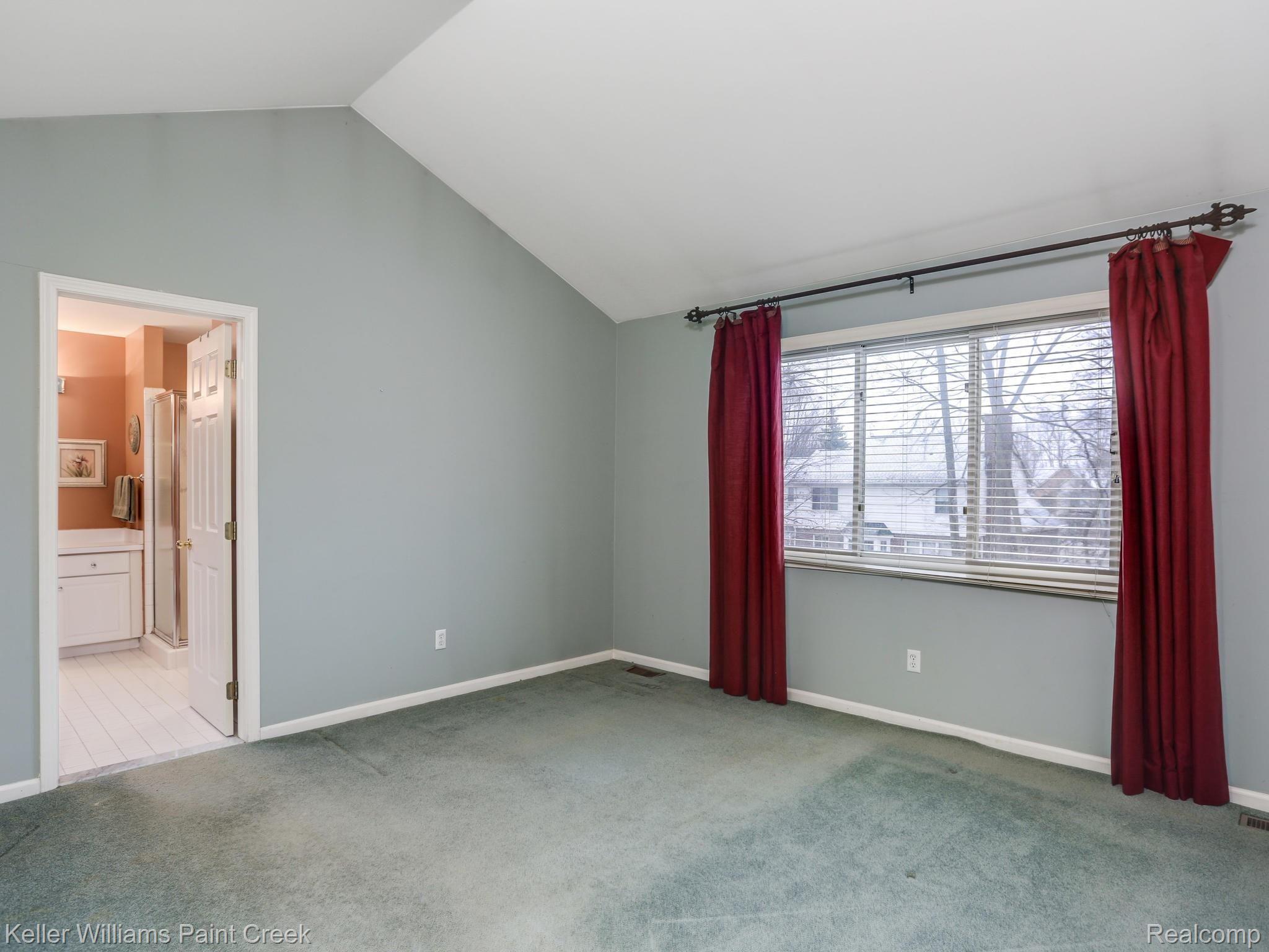 673 Lake Ridge Road Rochester, MI 48307 - Photo 14 of 26 The master suite on the upper level with back facing windows, cathedral ceilings and a deep walk-in closet!