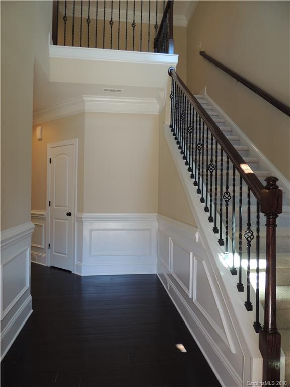 905 Ospre Lane, Unit 142 Fort Mill, SC 29708 - Photo 2 of 24 a view of staircase with lots of frames on wall and wooden floor