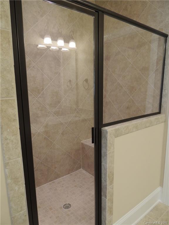 905 Ospre Lane, Unit 142 Fort Mill, SC 29708 - Photo 13 of 24 a bathroom with a glass shower door