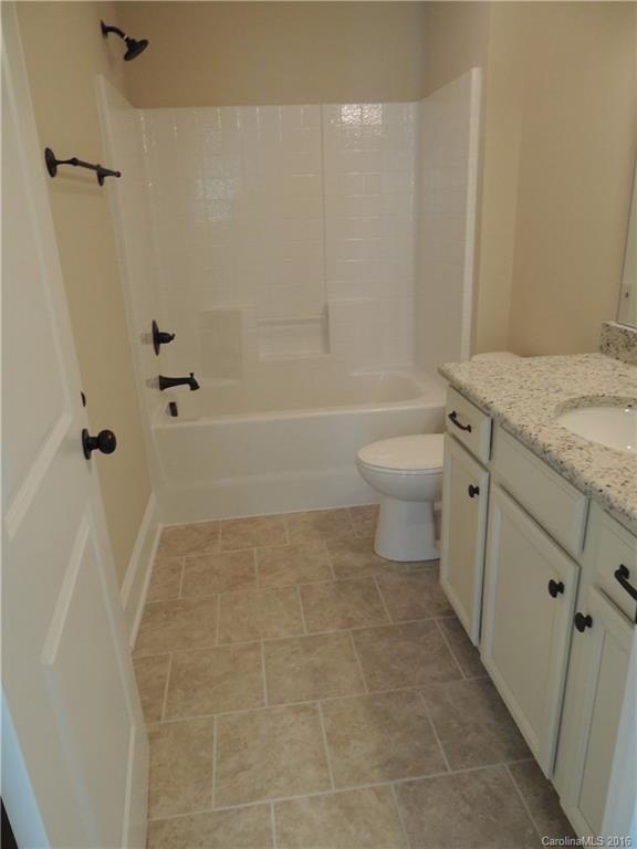 905 Ospre Lane, Unit 142 Fort Mill, SC 29708 - Photo 18 of 24 a bathroom with a granite countertop sink toilet and shower