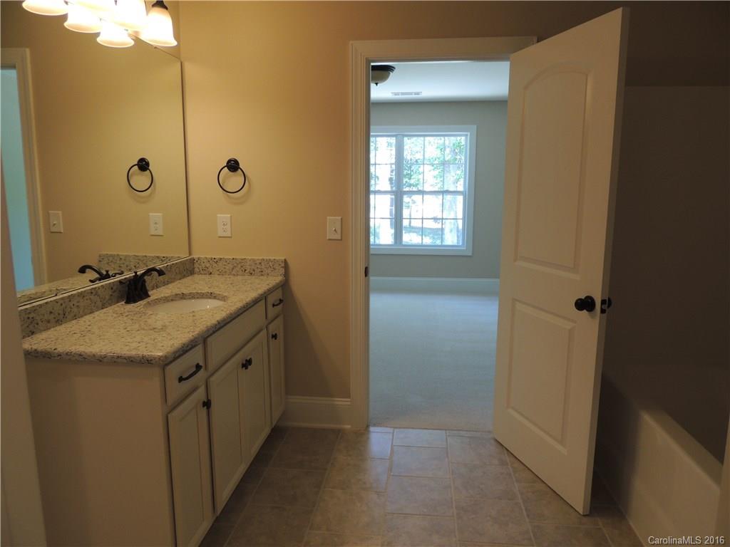 905 Ospre Lane, Unit 142 Fort Mill, SC 29708 - Photo 21 of 24 a bathroom with a granite countertop sink and a mirror