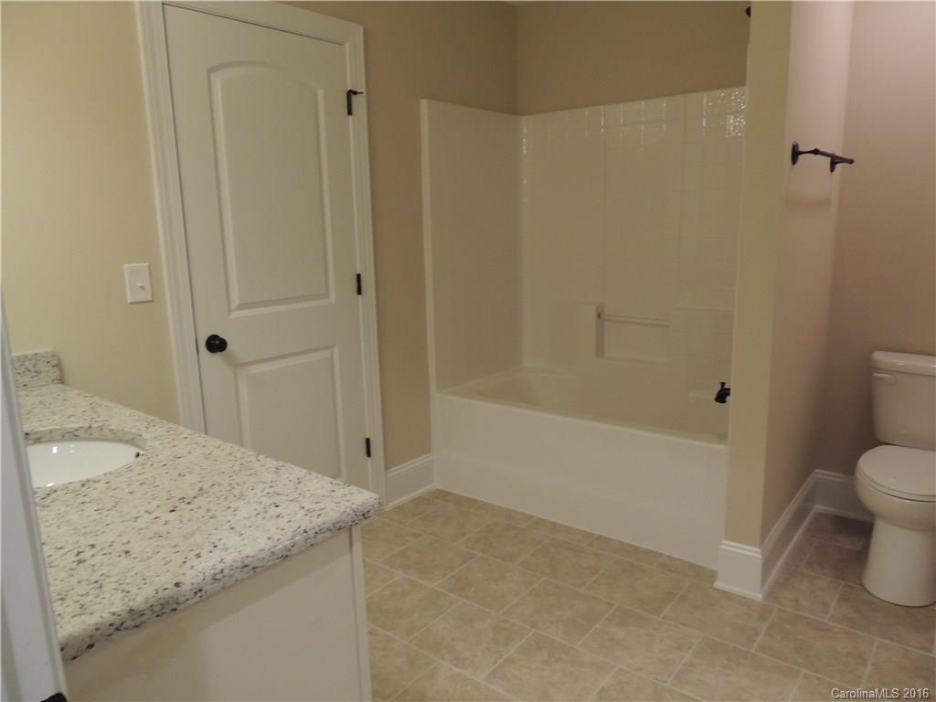 905 Ospre Lane, Unit 142 Fort Mill, SC 29708 - Photo 22 of 24 a bathroom with a granite countertop sink and a mirror