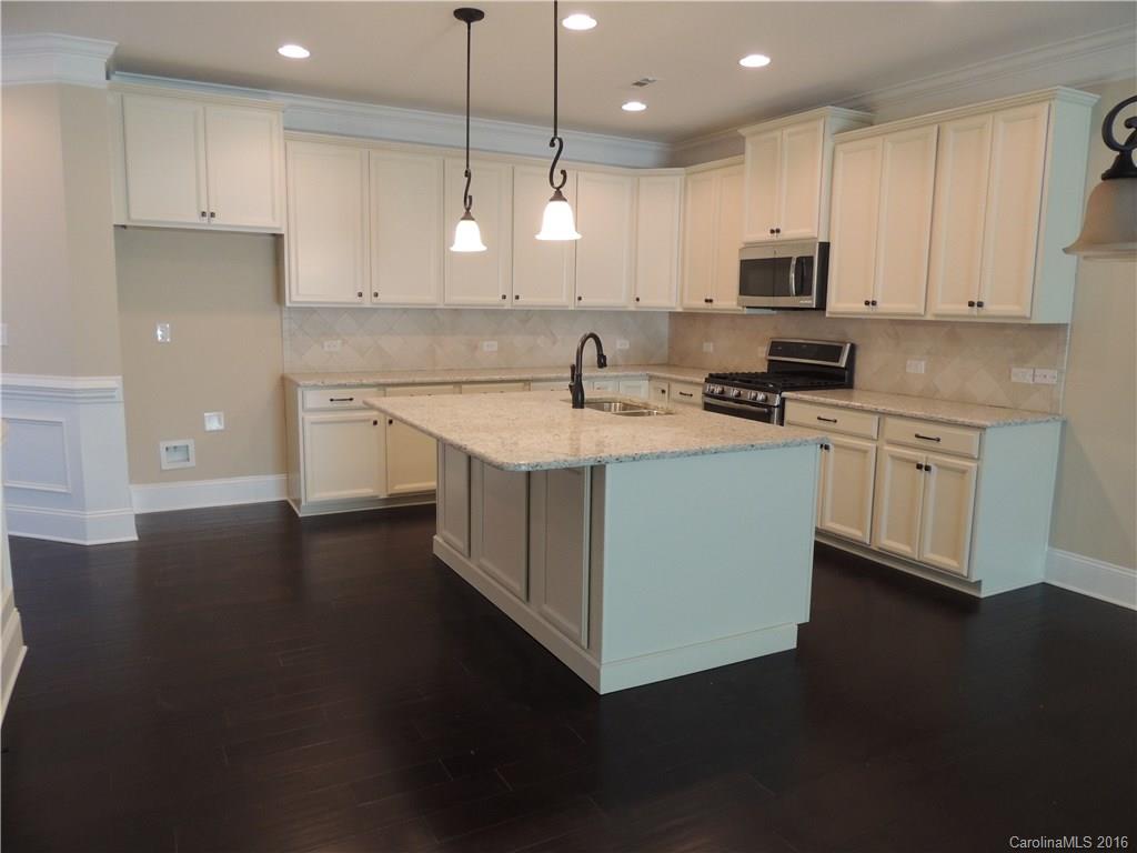 905 Ospre Lane, Unit 142 Fort Mill, SC 29708 - Photo 5 of 24 a kitchen with stainless steel appliances granite countertop a sink a stove and a refrigerator