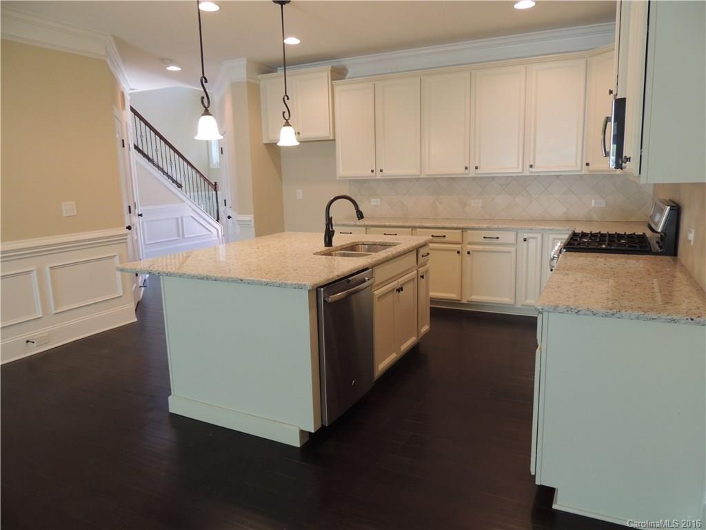 905 Ospre Lane, Unit 142 Fort Mill, SC 29708 - Photo 6 of 24 a kitchen with stainless steel appliances granite countertop a sink a stove and a refrigerator