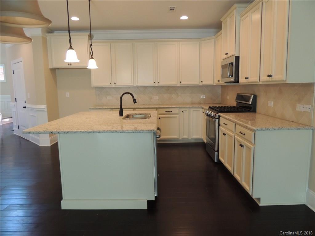 905 Ospre Lane, Unit 142 Fort Mill, SC 29708 - Photo 7 of 24 a kitchen with stainless steel appliances granite countertop a sink a stove and a refrigerator