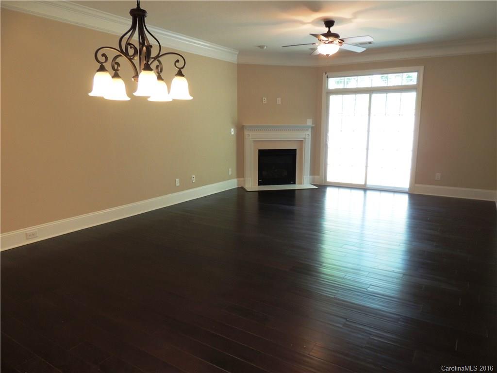 905 Ospre Lane, Unit 142 Fort Mill, SC 29708 - Photo 8 of 24 a view of empty room with wooden floor fan and window