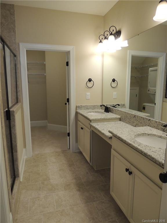 905 Ospre Lane, Unit 142 Fort Mill, SC 29708 - Photo 10 of 24 a bathroom with a granite countertop sink two mirror and a shower