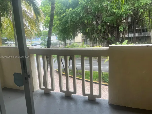 a view of a balcony with floor to ceiling window and wooden fence