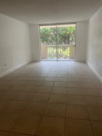 a view of an empty room with a floor to ceiling window and an empty room