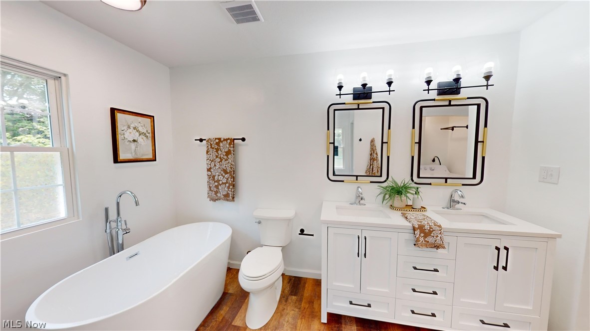 3075 Ludlow Road Cleveland, OH 44120 - Photo 22 of 30 2nd floor Bathroom with a wealth of natural light, wood-type flooring, dual vanity, and a bath