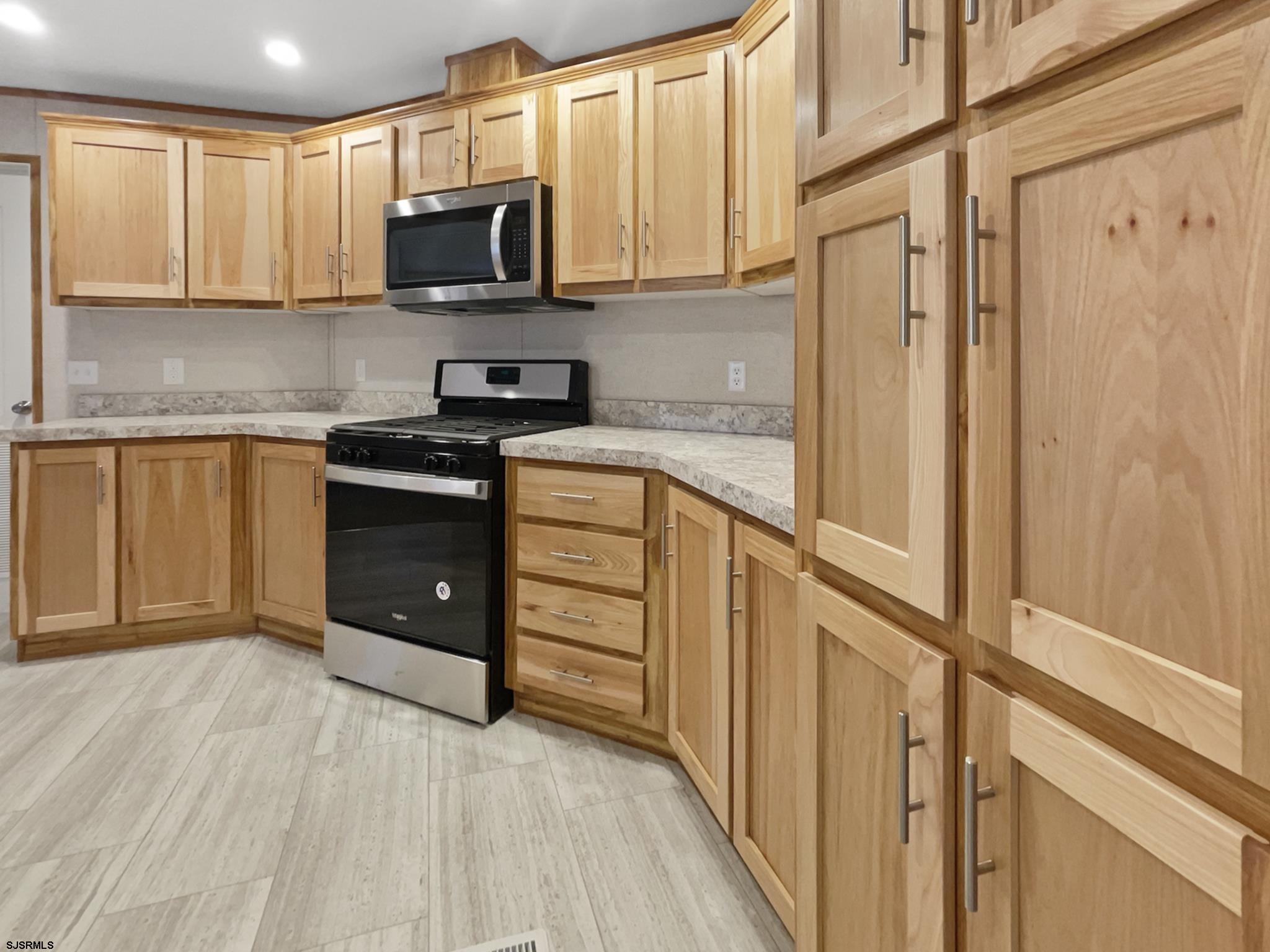 240 Mist Road Millville, NJ 08332 - Photo 12 of 48 a kitchen with stainless steel appliances granite countertop a stove a sink and a refrigerator