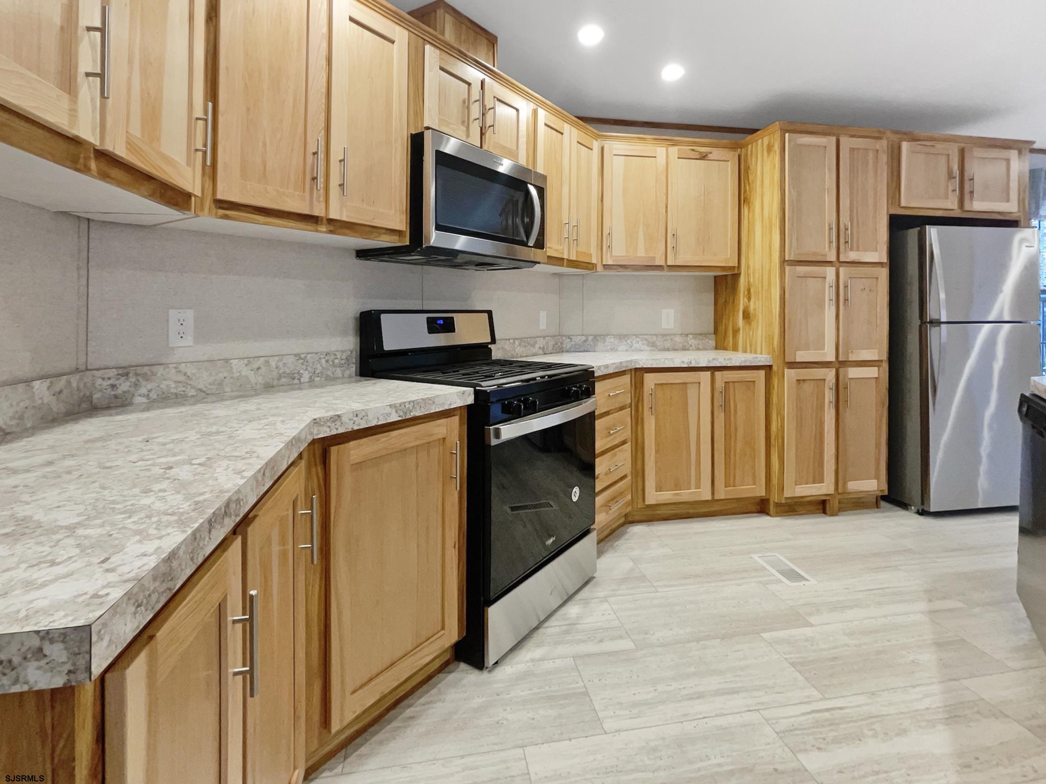 240 Mist Road Millville, NJ 08332 - Photo 13 of 48 a kitchen with stainless steel appliances granite countertop a refrigerator a stove top oven a sink and dishwasher