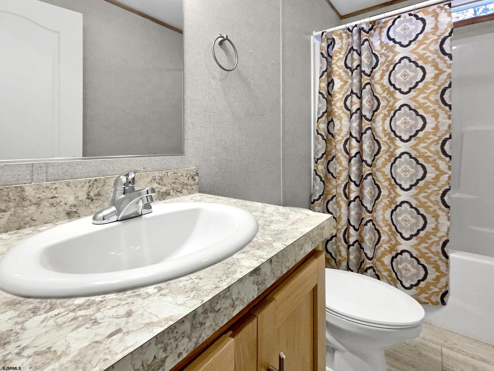240 Mist Road Millville, NJ 08332 - Photo 23 of 48 a bathroom with a sink and mirror with toilet