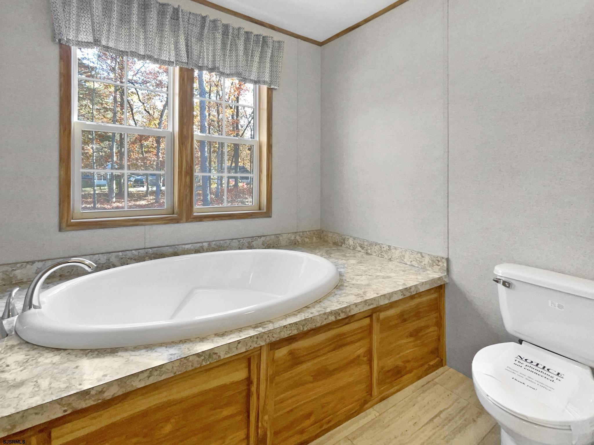 240 Mist Road Millville, NJ 08332 - Photo 26 of 48 a bathroom with a granite countertop sink and a toilet