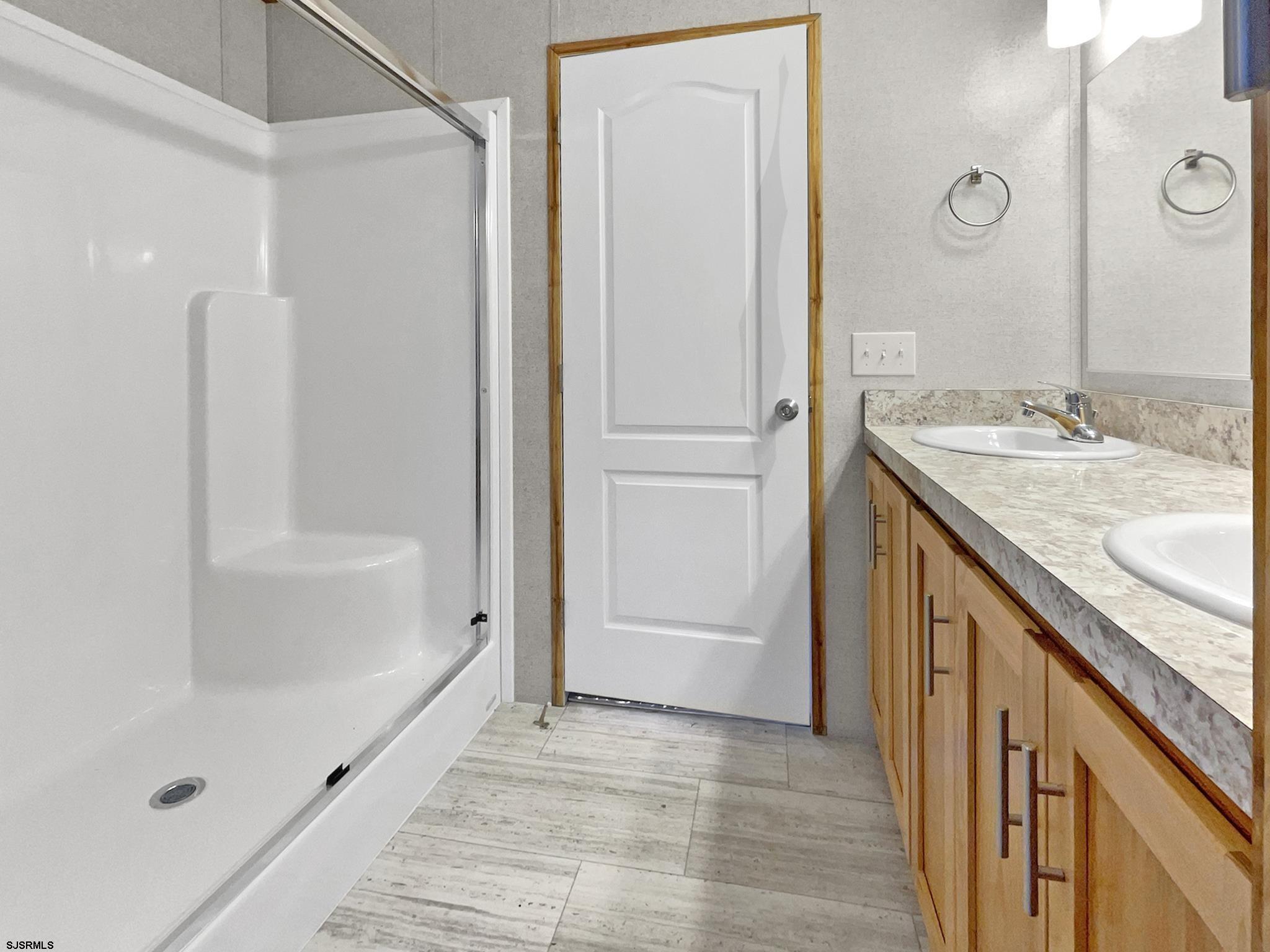 240 Mist Road Millville, NJ 08332 - Photo 28 of 48 a bathroom with a granite countertop sink a mirror and a bathtub