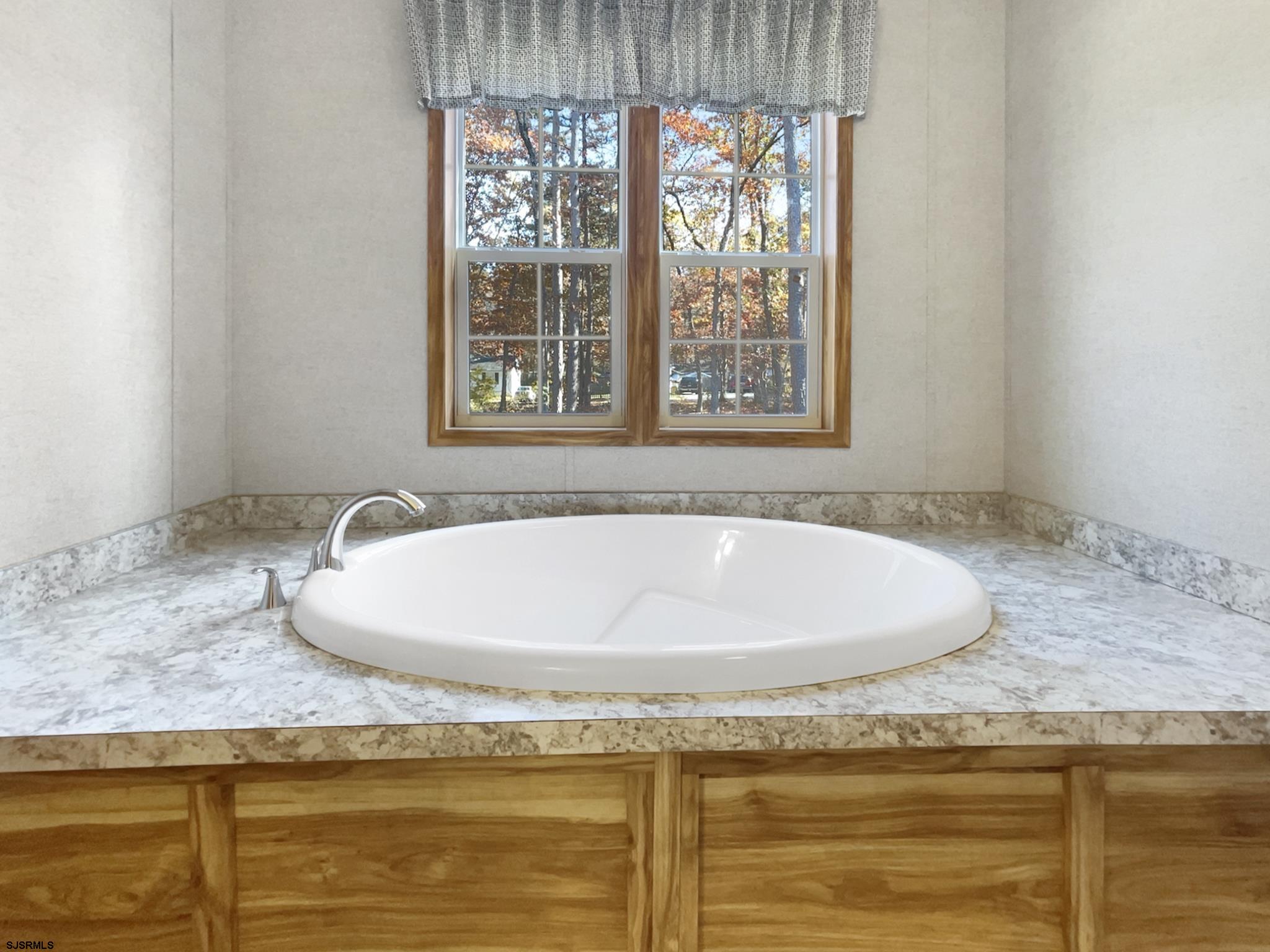 240 Mist Road Millville, NJ 08332 - Photo 36 of 48 a white bath tub sitting in a bathroom next to a window