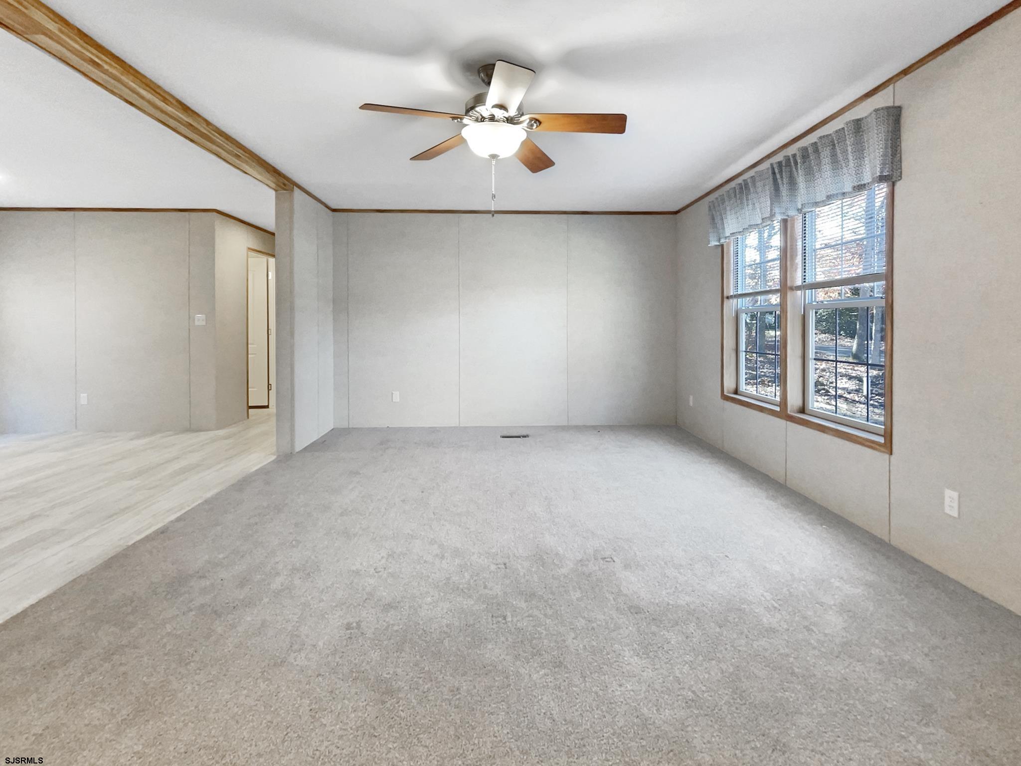 240 Mist Road Millville, NJ 08332 - Photo 6 of 48 an empty room with windows and ceiling fan