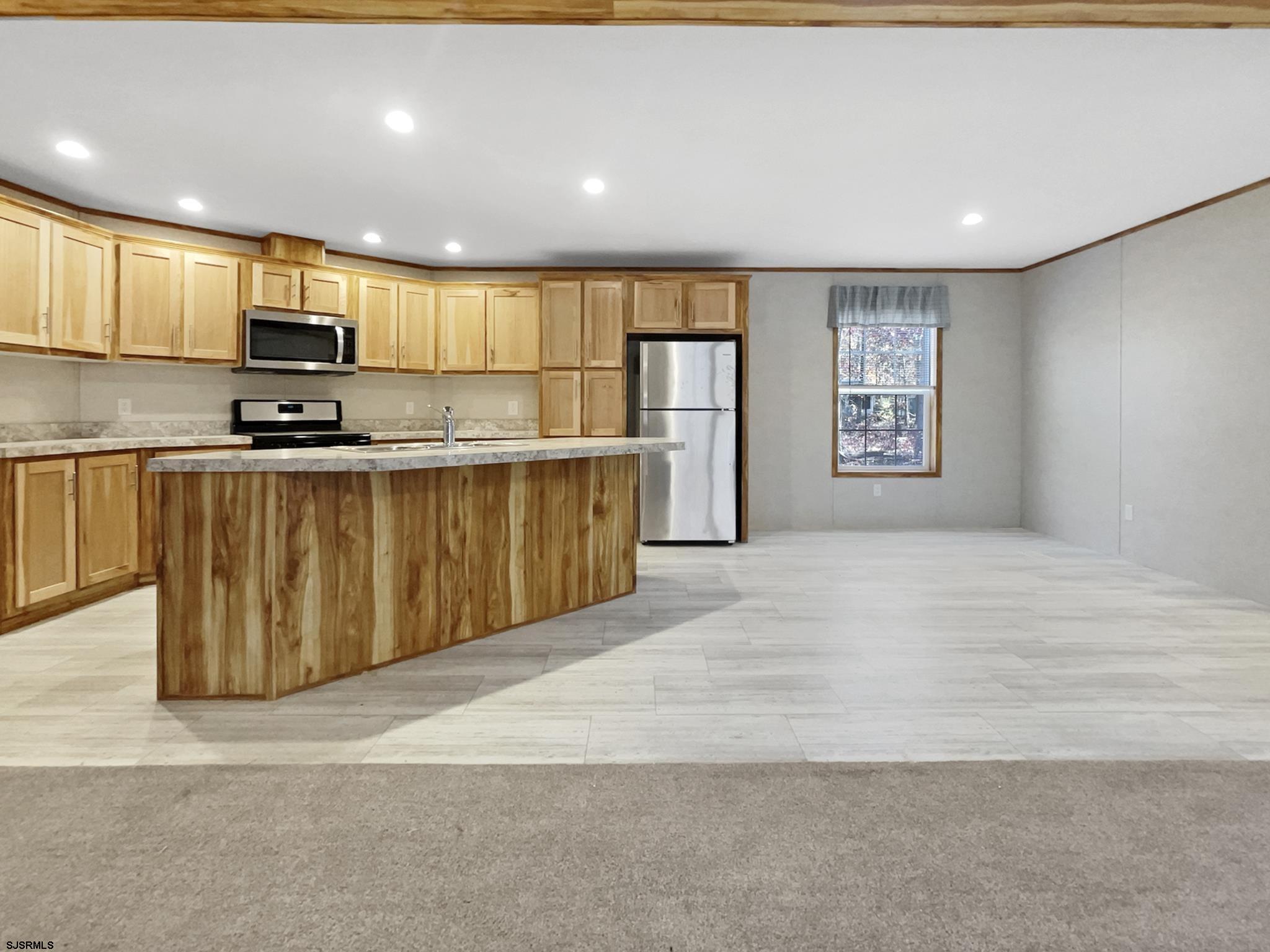 240 Mist Road Millville, NJ 08332 - Photo 8 of 48 a large kitchen with stainless steel appliances granite countertop a stove a sink dishwasher and a microwave with wooden floor