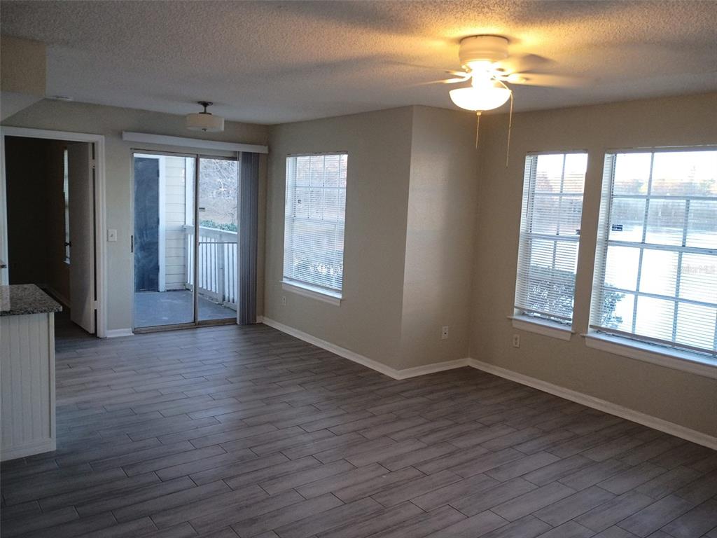 1037 South Hiawassee Road, Unit 2818 Orlando, FL 32835 - Photo 2 of 11 a view of an empty room with wooden floor and a window