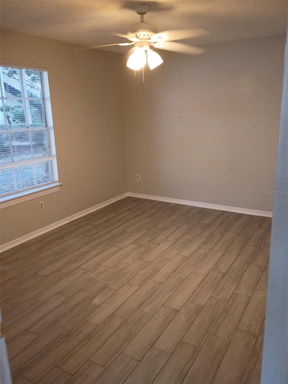 1037 South Hiawassee Road, Unit 2818 Orlando, FL 32835 - Photo 6 of 11 wooden floor in an empty room