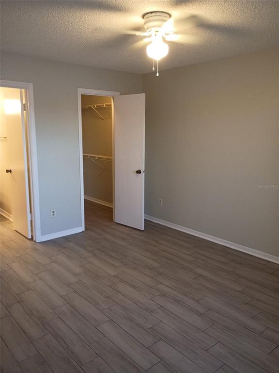 1037 South Hiawassee Road, Unit 2818 Orlando, FL 32835 - Photo 9 of 11 a view of an empty room with wooden floor and a window