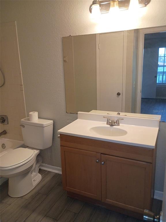 1037 South Hiawassee Road, Unit 2818 Orlando, FL 32835 - Photo 10 of 11 a bathroom with a sink toilet and mirror