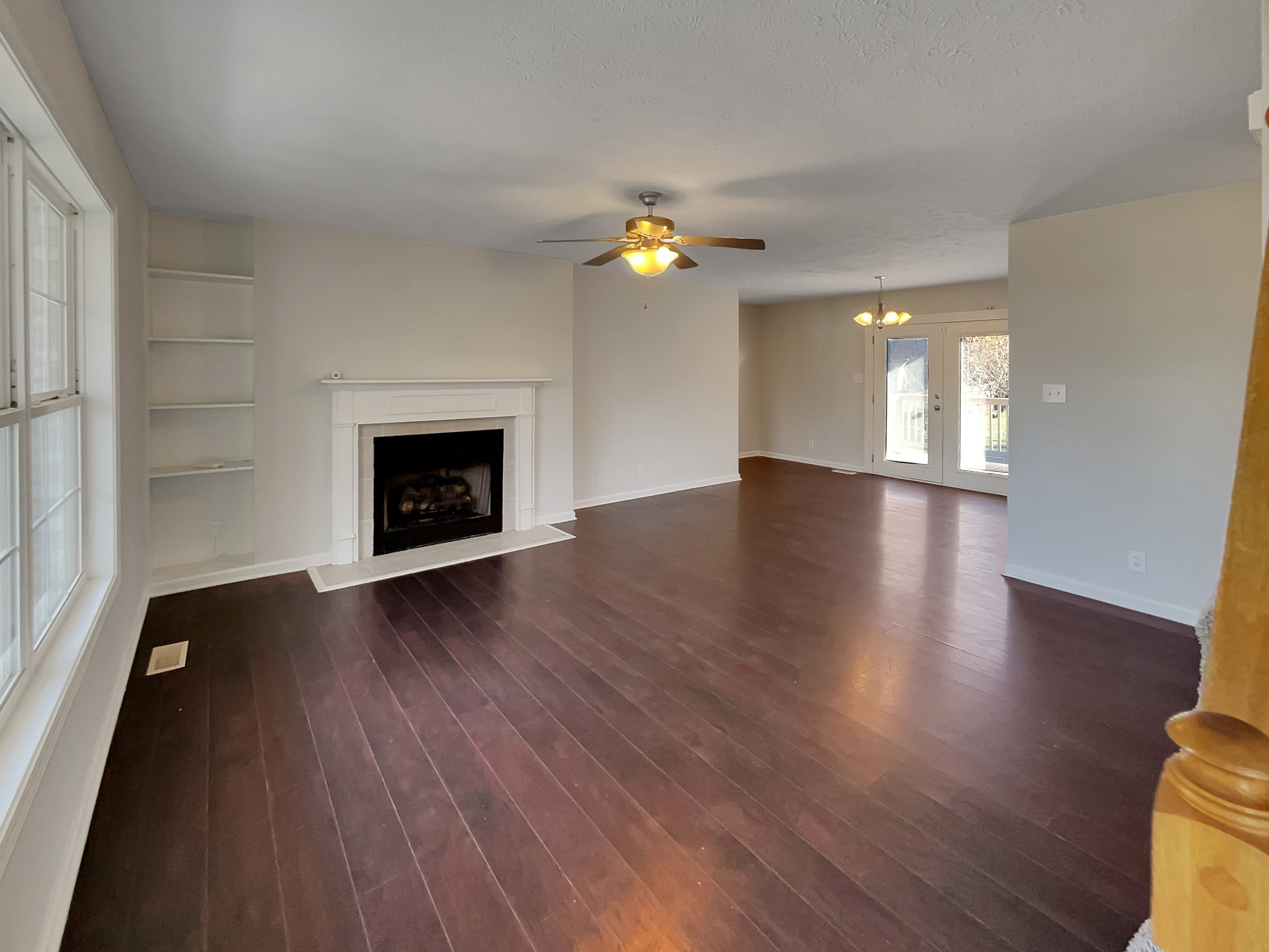 1837 Twin Rivers Road Clarksville, TN 37040 - Photo 3 of 19 an empty room with wooden floor fireplace and windows