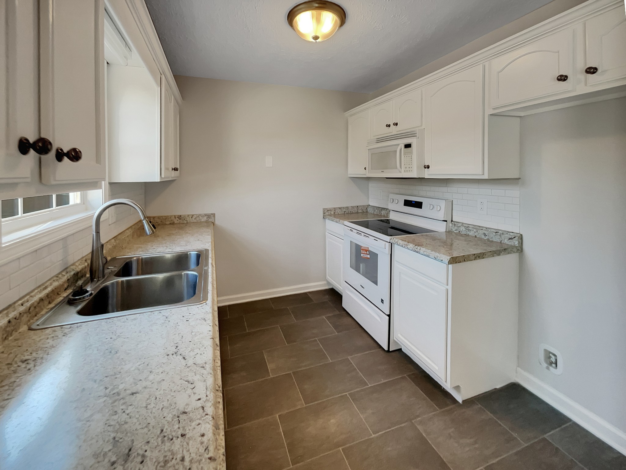1837 Twin Rivers Road Clarksville, TN 37040 - Photo 6 of 19 a kitchen with granite countertop a sink a stove and cabinets