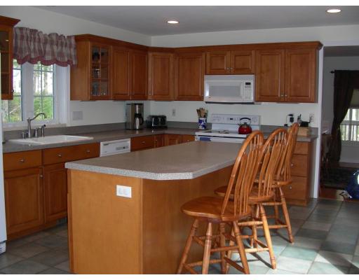 64 Sugar Road Bolton, MA 01740 - Photo 4 of 30 a kitchen with stainless steel appliances granite countertop a sink a stove a refrigerator and cabinets