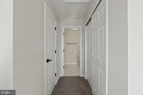 a view of a hallway with a wooden door