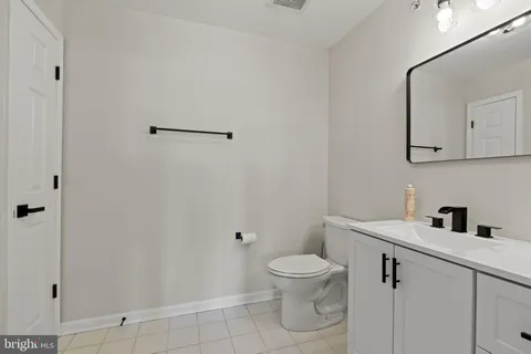 a white toilet sitting next to a bathroom sink