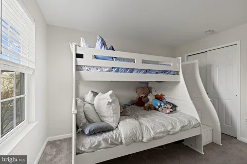 a bedroom with a bed and windows