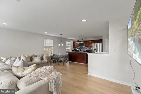 a living room with furniture and a kitchen area