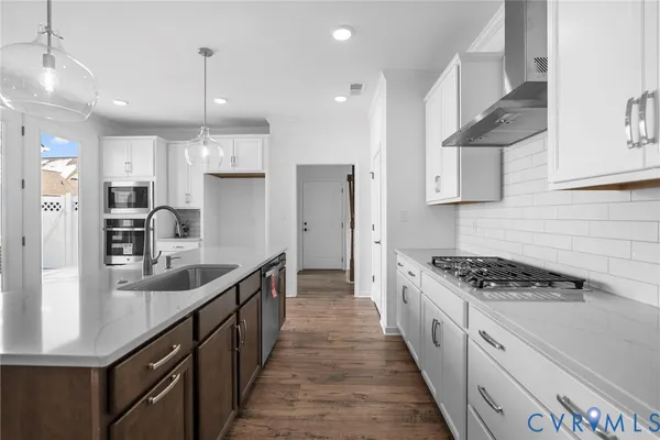 a kitchen with stainless steel appliances kitchen island a refrigerator and a sink