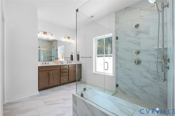 a bathroom with a granite countertop sink a toilet and shower