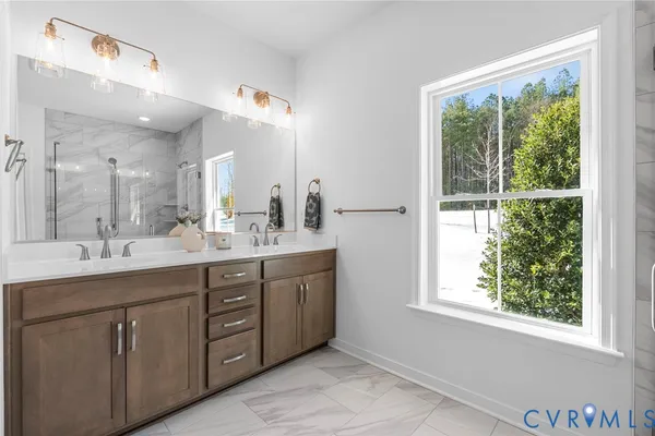 a bathroom with a double vanity sink and a mirror