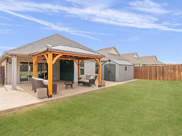 a view of a house with backyard porch and sitting area