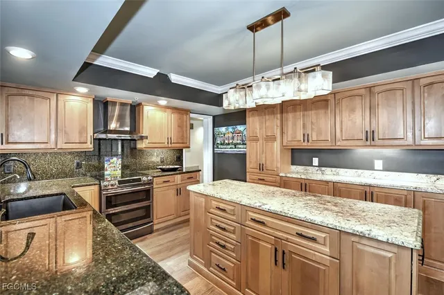 a kitchen with stainless steel appliances granite countertop a stove sink and cabinets