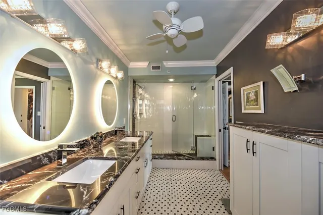 a bathroom with a double vanity sink mirror and